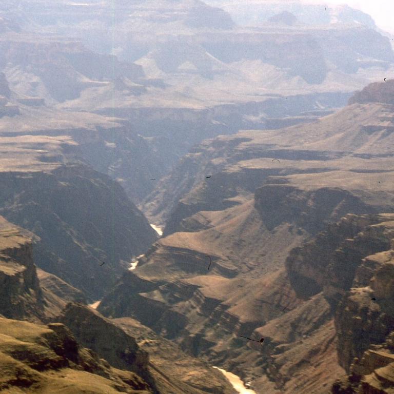 Weitläufige Panoramaaufnahme eines Canyon-Gebiets mit vielen geschichteten, trockenen Ebenen und Schluchten.